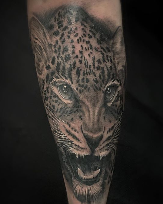 Cat's head tattoo by Sacred Mandala's Alan Lott - book your next custom tattoo in Durham, NC at Sacred Mandala Studio