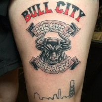Bull City - Burgery and Brewery with Durham Skyline upper thigh tattoo created at Sacred Mandala Studio in Durham, NC. 