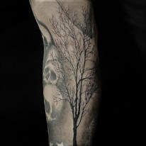 Alan Lott - forearm tattoo of a single backlit tattoo done in black and grey. 