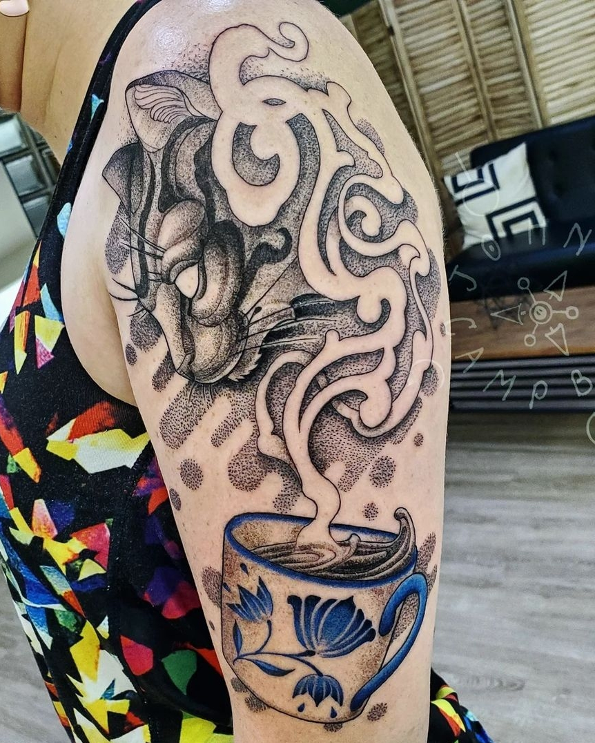 Cats head in smoke from blue teacup tattoo by John Campbell at Sacred Mandala Studio tattoo parlor in Durham, NC.